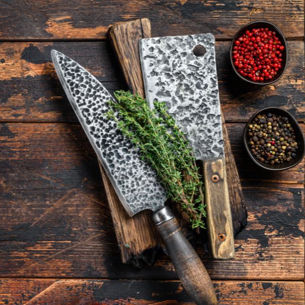chef and butcher knife on wooden chopping board